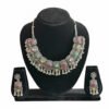 Oxidised silver necklace set with multi-color stones and matching earrings displayed on a black jewellery stand.